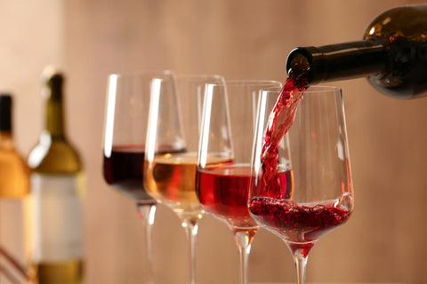 Red and white options of the best alcohol free wine poured into tasting glasses for comparison