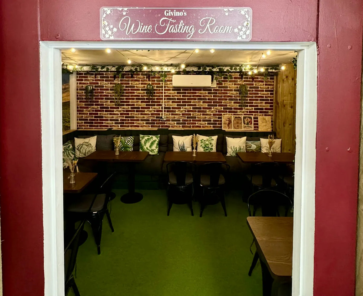 The doorway to Givino's Wine Tasting Room, the snug laid with tables inside
