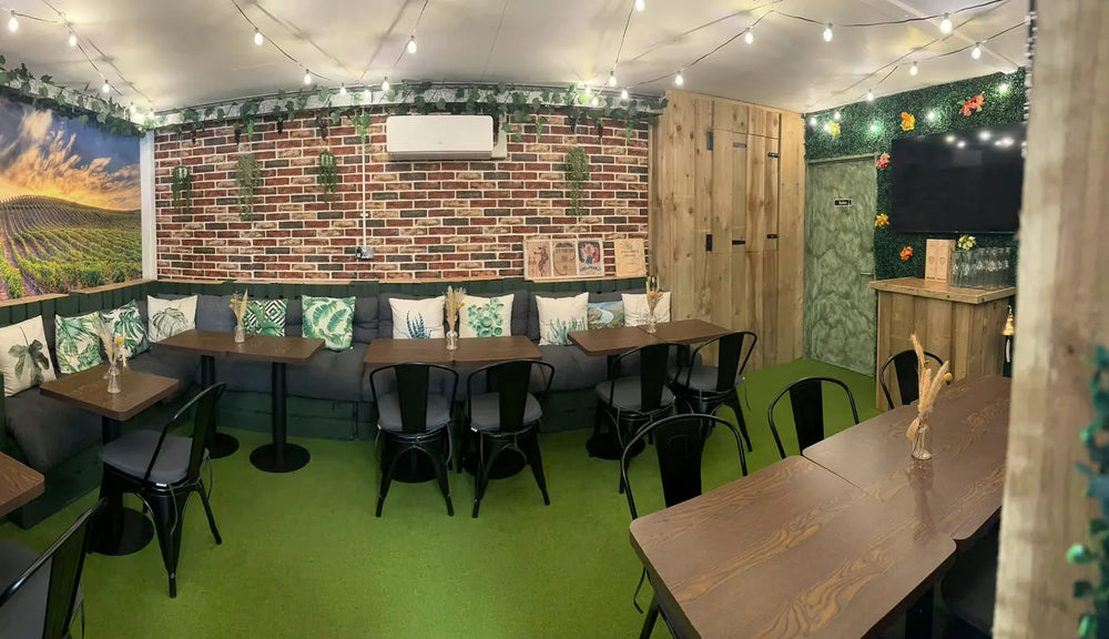 The snug laid for a tasting, with the vineyard mural on the far wall